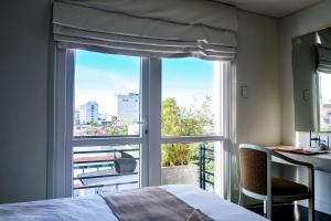 a bedroom with a window with a view of a city at Alba Spa Hotel in Hue +62 photos