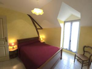 a bedroom with a bed and a chair and a window at Maison de campagne avec wifi près de Thenon, 3 chambres - FR-1-616-138 in Azerat