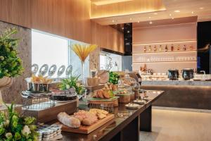 a buffet line with bread and pastries on display at United Hotel in Taipei