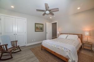 a bedroom with a bed and a ceiling fan at Anchorage Haus in Fredericksburg