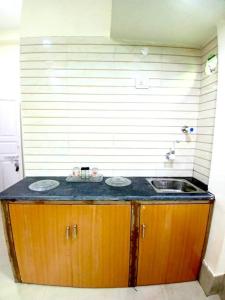 a bathroom with a sink and a counter at Studio Room Close to Quest Mall in Kolkata
