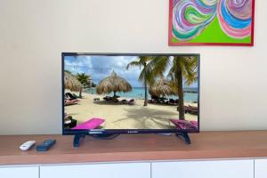 a flat screen tv sitting on top of a counter at Guest Favorite - Central - Gated - 2 Bedrooms in Willemstad +10 photos