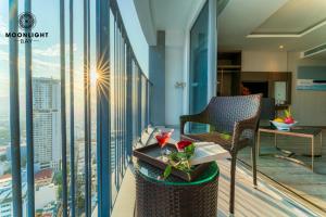 a balcony of a hotel with a table and a chair at Nha Trang Superview Holidays in Nha Trang