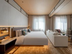 a bedroom with a large white bed and a couch at The Imperial Dragon Phoenix Mansion Wangfujing Tiananmen Beijing in Beijing +74 photos