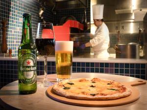 a pizza and a bottle of beer and a glass of wine at Shinjuku Prince Hotel in Tokyo