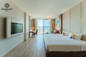 a hotel room with a large bed and a television at Nha Trang Superview Holidays in Nha Trang