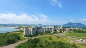 an aerial view of a resort and the ocean at Phoenix Island in Seogwipo