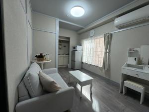 a living room with a couch and a table at KOBAYASHi 東京 in Tokyo