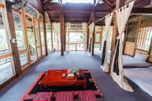 a room with beds and a table in a house at The Nordic Village - Evergreen Retreat in Mộc Châu +249 photos