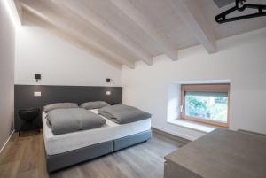 Postel nebo postele na pokoji v ubytování La Giostra Deluxe Apartments