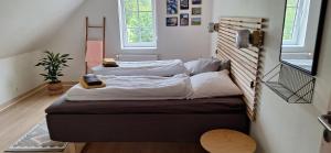 two beds in a small room with at Groennebaek Bed and Breakfast in Føvling