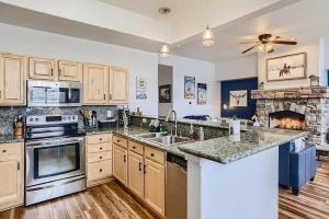 a kitchen with marble counter tops and a fireplace at 152 Ponds on the Blue River home in Silverthorne