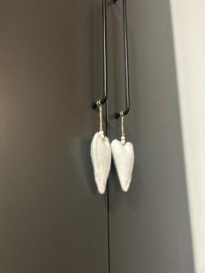 a pair of heart earrings hanging on a wall at Appartamento da Bunny & Brownie in Noventa di Piave