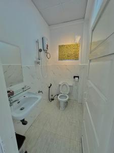 a white bathroom with a sink and a toilet at 1 House 1 in Da Lat +26 photos