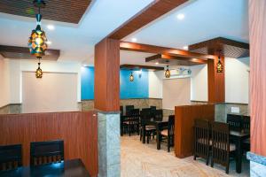 a dining area with tables and chairs in a restaurant at Hotel Skylights Bangalore Airport in Muthugadahalli