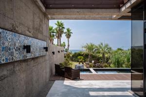 a house with a view of the ocean at Ceylon Jeju Pool Villa in Jeju