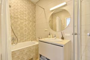 a bathroom with a sink and a tub and a mirror at Home In 2 in Druskininkai +35 photos