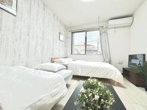 Postel nebo postele na pokoji v ubytování ティエラ北池袋