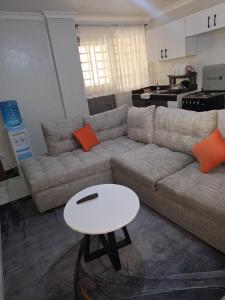 a living room with a couch and a table at Rayvin homes in Thika