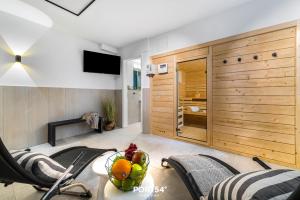 a living room with a table with a bowl of fruit on it at Ferienwohnung Auftanken St Peter Ording in Sankt Peter-Ording