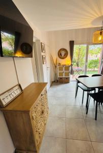 a kitchen with a table and a dining room at La Villa Sylody in Lecci