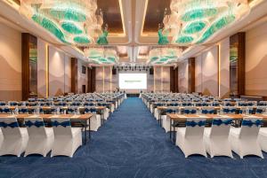 a large room with rows of tables and chairs at Wyndham Garden Sonasea Van Don in Cái Rồng +81 photos