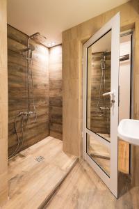 a bathroom with a shower and a sink at Stylish apartment, Top center! in Sofia +5 photos