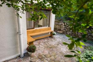 a window with a wooden bench next to a building at Stylish apartment, Top center! in Sofia