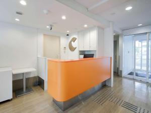an office with an orange counter in the middle of a room at Comfort Inn Tosu in Tosu