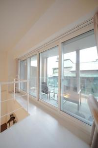 a large window in a living room with a balcony at Pillowbook Accommodations Otaru Kaihoro 106 in Otaru +40 photos