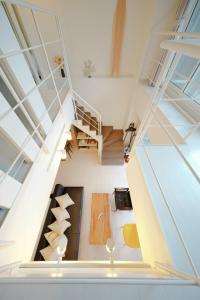 an attic room with a spiral staircase in a house at Pillowbook Accommodations Otaru Kaihoro 106 in Otaru