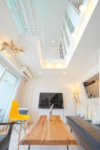 a living room with a couch and a table at Pillowbook Accommodations Otaru Kaihoro 106 in Otaru