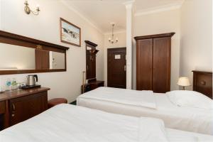 Postel nebo postele na pokoji v ubytování Royal Hotel Modlin