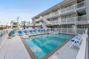 Una piscina con sillas y un hotel. en 7203 Atlantic Ave, Unit 205, en Wildwood Crest