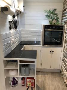 a small kitchen with a counter and a microwave at The Nook in Padstow