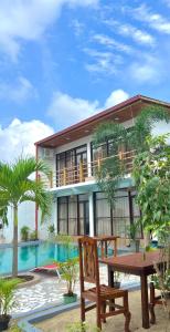a house with a table and chairs in front of it at Maccan's Village in Arugam Bay +88 photos