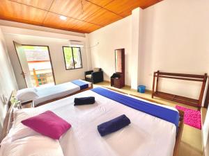 a bedroom with two beds with pillows on them at Maccan's Village in Arugam Bay