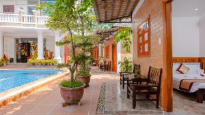 a hotel room with a bed and a swimming pool at Duy Ngoc Resort Phu Quoc in Phu Quoc