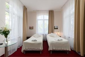 Postel nebo postele na pokoji v ubytování Modlin Palace