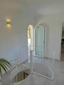a white room with a table and two mirrors at Bonaire Beach House in Alcudia