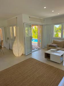 a living room with a couch and a table at Bonaire Beach House in Alcudia