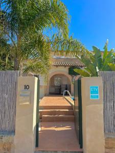 a house with a gate with the number on it at Bonaire Beach House in Alcudia