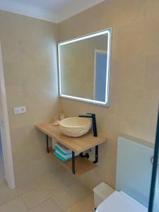 a bathroom with a sink and a mirror at Bonaire Beach House in Alcudia