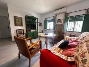 a living room with a couch and a table at El Cortijo in Archidona