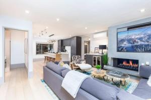 a living room with a couch and a fireplace at New 2 BR 2 and a half Bath - Luxurious Aspen Mountain Modern! in Aspen