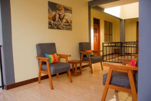 a waiting room with three chairs and a table at Hecasa Apartments in Arusha