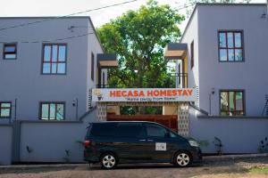 a black van parked in front of a building at Hecasa Apartments in Arusha