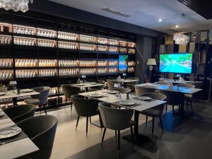 a dining room with tables and chairs and a tv at Montana Luxury Vue in Poiana Brasov