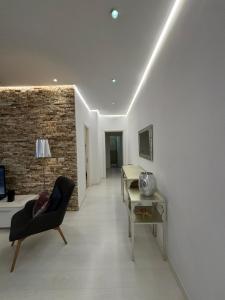 a living room with a black chair and a table at TAM Serviced 2BDR Apartment City Center No6 in Tirana
