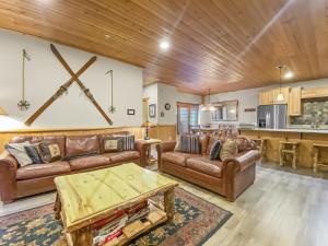 a living room with leather couches and a table at 3D Timberwolf Mountain Retreat condo in Park City